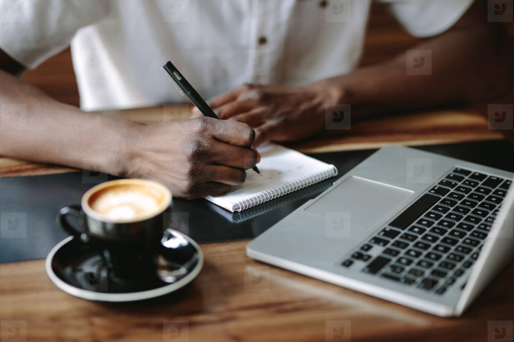 Retired couple calmly reviewing side hustle ideas at home using a laptop and notebook
